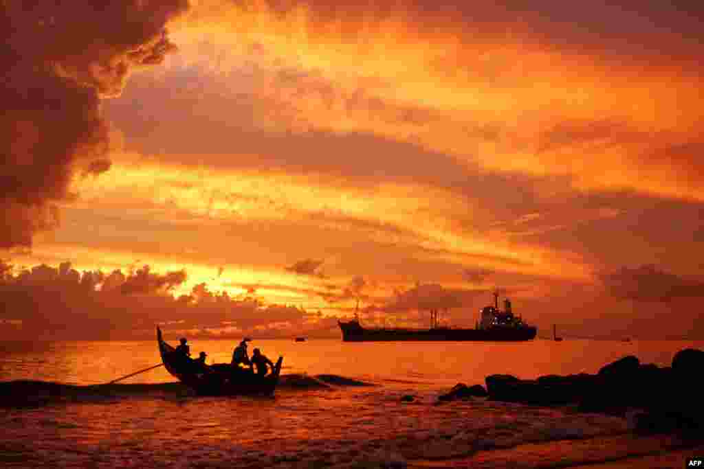 A fishing boat heads out to sea at dawn in Lhokseumawe, Aceh, Indonesia.