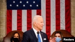President Joe Biden addresses a joint session of Congress, with Vice President Kamala Harris and House Speaker Nancy Pelosi on the dais behind him, April 28, 2021. 