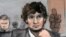 In this courtroom sketch, Dzhokhar Tsarnaev, center, is depicted between defense attorneys Miriam Conrad, left, and Judy Clarke, right, during his federal death penalty trial, Thursday, March 5, 2015, in Boston. Tsarnaev is charged with conspiring with hi