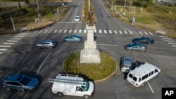 FILE - Traffic drives in the circle at the monument of confederate General A.P. Hill, which contains his remains, is in the middle of a traffic circle on Arthur Ashe Blvd. Jan. 6, 2022, in Richmond, Virginia. 