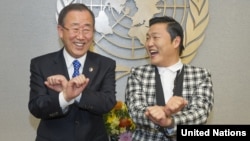 UN Secretary-General Ban Ki-moon, left, is taught how to dance 'Gangnam Style' by Korean rapper PSY during a photo opportunity at the UN headquarters in New York, October 23, 2012.