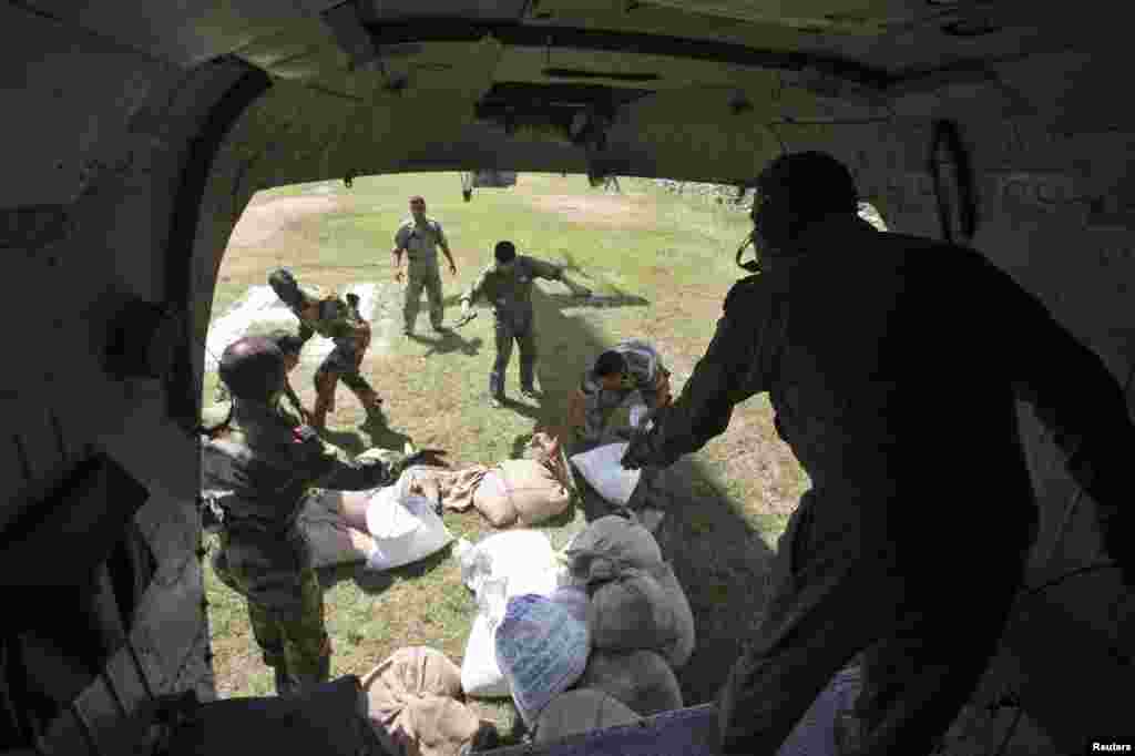 Soldiers unloading relief materials from an Indian Air Force helicopter near Reasi, Sept. 9, 2014.