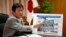 Japan's Economy, Trade and Industry Minister Toshimitsu Motegi, points to a board showing an overview of countermeasures planned for Tokyo Electric Power Co. (TEPCO)'s tsunami-crippled Fukushima Daiichi nuclear power plant, during an interview with Reuter