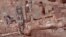 This undated photo provided by the Greek Ministry of Culture on Nov. 13, 2018, shows remains of walls and floors, probably from houses, from the lost ancient city of Tenea. 