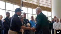 President Joe Biden shakes hands with Florida Chief Financial Officer and State Fire Marshal Jimmy Patronis during a meeting with first responders in Miami Beach, Fla., Thursday, July 1, 2021. (AP Photo/Susan Walsh)