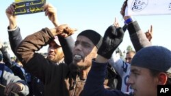 Muslim fundamentalists shout slogans during a protest in Tunis, Dec. 17, 2013 to mark the third anniversary of the Tunisian uprising. 