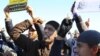 Muslim fundamentalists shout slogans during a protest in Tunis, Dec. 17, 2013 to mark the third anniversary of the Tunisian uprising. 