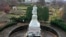 FILE - This is a statue of Christopher Columbus in the Oakland neighborhood of Pittsburgh, Pennsylvania, that was wrapped to protect it from vandalism, Nov. 26, 2020. 