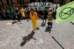Climate protesters from the Extinction Rebellion movement demonstrate at Town Hall in Sydney, Australia, Oct. 8, 2019.