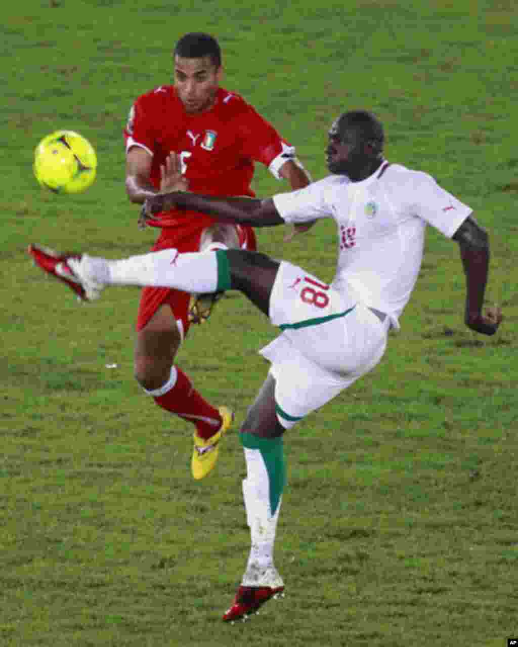 Edjogo of Equatorial Guinea challenges N'Daw of Senegal during their African Nations Cup Group A soccer match at Estadio de Bata