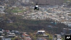 Marine One helicopter carrying President Donald Trump surveys areas impacted by Hurricane Maria, Oct. 3, 2017, near San Juan, Puerto Rico.