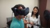 Keck School of Medicine of USC assistant professor Judy Pa watches as Wayne Garcia participates in a study that looks at whether virtual reality combined with exercise can prevent dementia. (E. Lee/VOA)