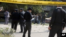 Egyptian policemen and explosives experts look for evidence at the site of a bomb explosion in Cairo, Egypt, Dec. 9, 2016. 