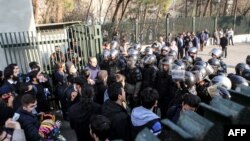 FILE - Iranian students scuffle with police at the University of Tehran during a demonstration driven by anger over economic problems, in the capital Tehran, Iran, Dec. 30, 2017. 