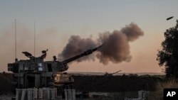 An Israeli artillery unit fires on Gaza Strip, on the Israel-Gaza border, May 18, 2021. 