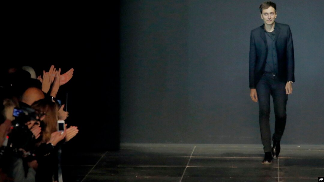 FILE - This Monday, Oct.1, 2012 file photo shows French-born fashion designer Hedi Slimane for Yves St Laurent appearing at the end of his ready to wear Spring-Summer 2013 collection presented in Paris. 