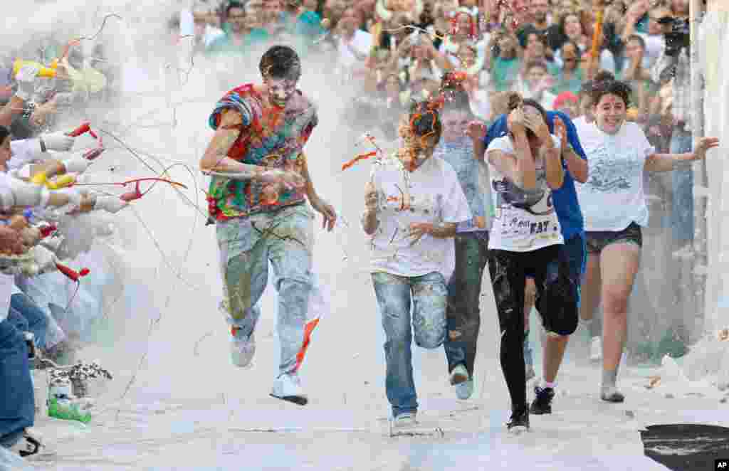 October 19: Faculty of medicine first year students get sprayed with different types of sauces, liquids and flour by seniors, as part of an annual tradition in honour of their patron Saint Lucas at Granada University in southern Spain. REUTERS/Pepe Marin