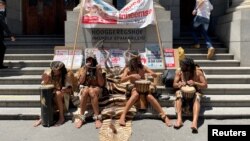 Members of the Khoi, an indigenous group, picket outside the high court during a hearing, as they oppose development of the new Africa headquarters and residential buildings of U.S. retail giant Amazon, in Cape Town, South Africa, Jan. 21, 2022.