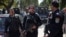 Egyptian police officers take positions during the arrest of Ahmed Qaddaf al-Dam, Cairo, March 19. 2013.