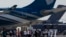 FILE - Visitors watch the flying display during the first day of the Dubai Airshow, November 2011.