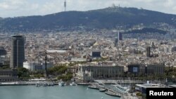 FILE - A view of Barcelona, with Maremagnum and Port Vell at habor, in Barcelona, Spain.