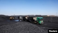 FILE: A truck loaded with coal drives off at Canyon Coal's Khanye colliery near Bronkhorstspruit, around 90 kilometers north-east of Johannesburg, South Africa. Taken April 26, 2022.