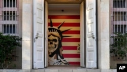 The entranceway  to the erstwhile  US Embassy, which has been turned into an anti-American museum, is seen with a satirized representation  of the Statue of Liberty and the US emblem  successful  Tehran, Iran, Oct. 22, 2024.