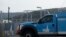 FILE - A Pacific Gas and Electric truck drives past a PG&E location in San Francisco, Feb. 20, 2020.