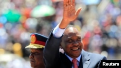 Kenya's President Uhuru Kenyatta arrives to attend Mashujaa (Heroes) Day at the Nyayo National Stadium in capital Nairobi, Oct. 20, 2013. 