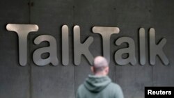 A man walks past a company logo outside a TalkTalk building in London, Oct. 23, 2015.