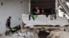 Palestinians take shelter in a heavily damaged building at Saftawi street in Jabalia in the northern Gaza Strip on Feb. 5, 2025, during a ceasefire deal in the war between Israel and Hamas. 