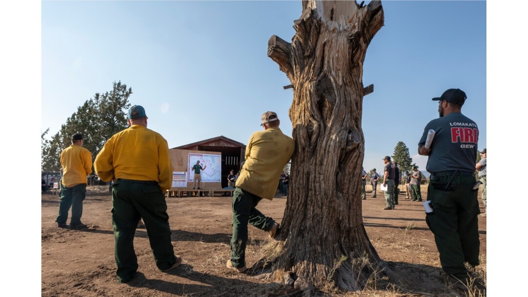 Bomberos de todo el país escuchan una sesión informativa antes de comenzar un turno en la lucha contra el incendio Bootleg, el jueves 22 de julio de 2021 cerca de Bly, Oregon (AP Photo / Nathan Howard)