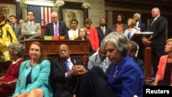 A photo shot and tweeted from the floor of the U.S. House of Representatives by U.S. House Rep. Katherine Clark shows Democratic members of the House staging a sit-in on the House floor "to demand action on common sense gun legislation" on Capitol Hill in Washington, United States, June 22, 2016. U.S. Rep. Katherine Clark/Handout via Reuters. 