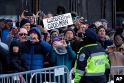 Orang-orang menyaksikan iring-iringan pembawa peti jenazah mantan Presiden Jimmy Carter di Pennsylvania Avenue di Washington, Selasa, 7 Januari 2025, dalam perjalanan menuju Gedung DPR AS. Carter meninggal pada 29 Desember 2024, pada usia 100 tahun. (Susan Walsh, Pool/AP)