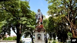 A vandalized statue of Christopher Columbus towers over Columbus Square in Port of Spain, Trinidad and Tobago, Aug. 28, 2024. 