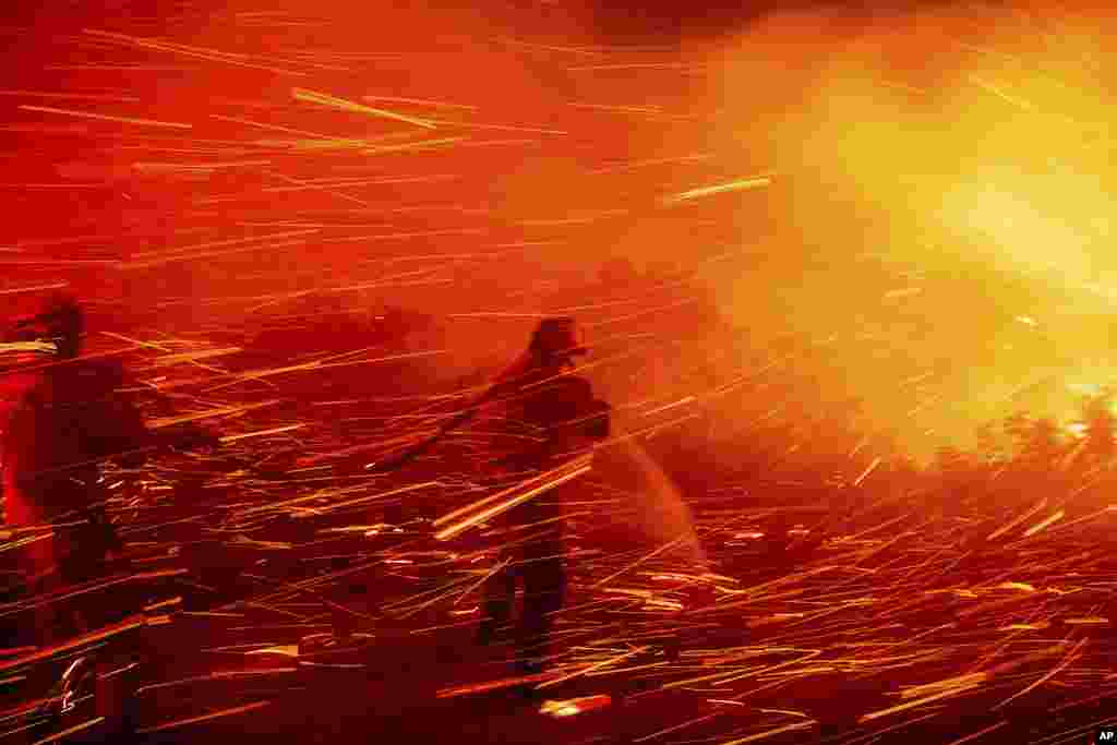 Firefighters battle the Lilac Fire near the Bonsall community of San Diego County, California.