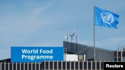 FILE - A World Food Program's flag flutters on the roof of WFP's headquaters after the WFP won the 2020 Nobel Peace Prize, in Rome, Italy, Oct. 9, 2020.