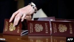 Ukraine -- Passports of the Russian Federation lie on a table as Crimean residents receive them in Simferopol, on April 15, 2014