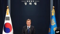 FILE - South Korea's new President Moon Jae-In speaks at the presidential Blue House in Seoul. 