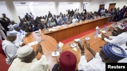 International Monetary Fund (IMF) Managing Director Christine Lagarde is applauded after speaking to members of parliament at the National Assembly in Abuja, Nigeria, in this January 6, 2016 handout photo by IMF. REUTERS/Stephen Jaffe/IMF Staff Photo/Hand