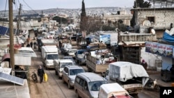 Civilians flee from Idlib toward the north to find safety inside Syria near the border with Turkey, Saturday, Feb. 15, 2020. Syrian troops are waging an offensive in the last rebel stronghold. (AP Photo)