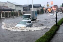 A street is flooded by heavy rain, Oct. 25, 2019, in Narita, east of Tokyo.