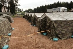 FILE - A general view of the newly installed tents in Lithuania's migrant processing center in Pabrade, Lithuania, June 15, 2021.