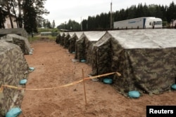FILE - A general view of the newly installed tents in Lithuania's migrant processing center in Pabrade, Lithuania, June 15, 2021.