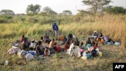 A group of South Sudanese refugees fleeing from recent fighting in Lasu in South Sudan rest after crossing the border into the Democratic Republic of Congo, near Aba, Dec. 23, 2017.