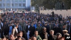 Supporters of Afghanistan's leading presidential candidate, Abdullah Abdullah, march during a mass demonstration in Kabul, Afghanistan, Nov. 29, 2019.