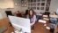 In this Dec. 4, 2017, image made from a video, Eleanor McManus works at her desk at Trident DMG, the Washington public relations firm she co-founded.