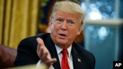 President Donald Trump speaks during an interview with The Associated Press in the Oval Office of the White House, Oct. 16, 2018.