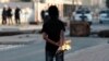 An anti-government protester prepares to throw a gas bomb at riot police during clashes in Malkiya village, Bahrain, January 7, 2013.