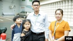 FILE - Former Radio Free Asia reporters Yeang Sothearin and his family pose for picture outside Phnom Penh Municipal Court Friday, August 30, 2019. (Tum Malis/VOA Khmer)